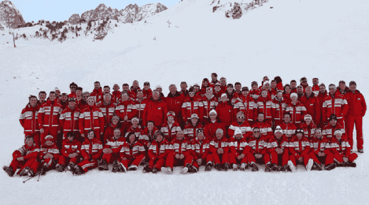 image de groupe des moniteurs esf habillés en rouge dans la neige